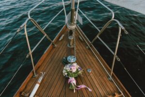 A bridal bouquet on a yacht deck overlooking the ocean, capturing a serene nautical theme.