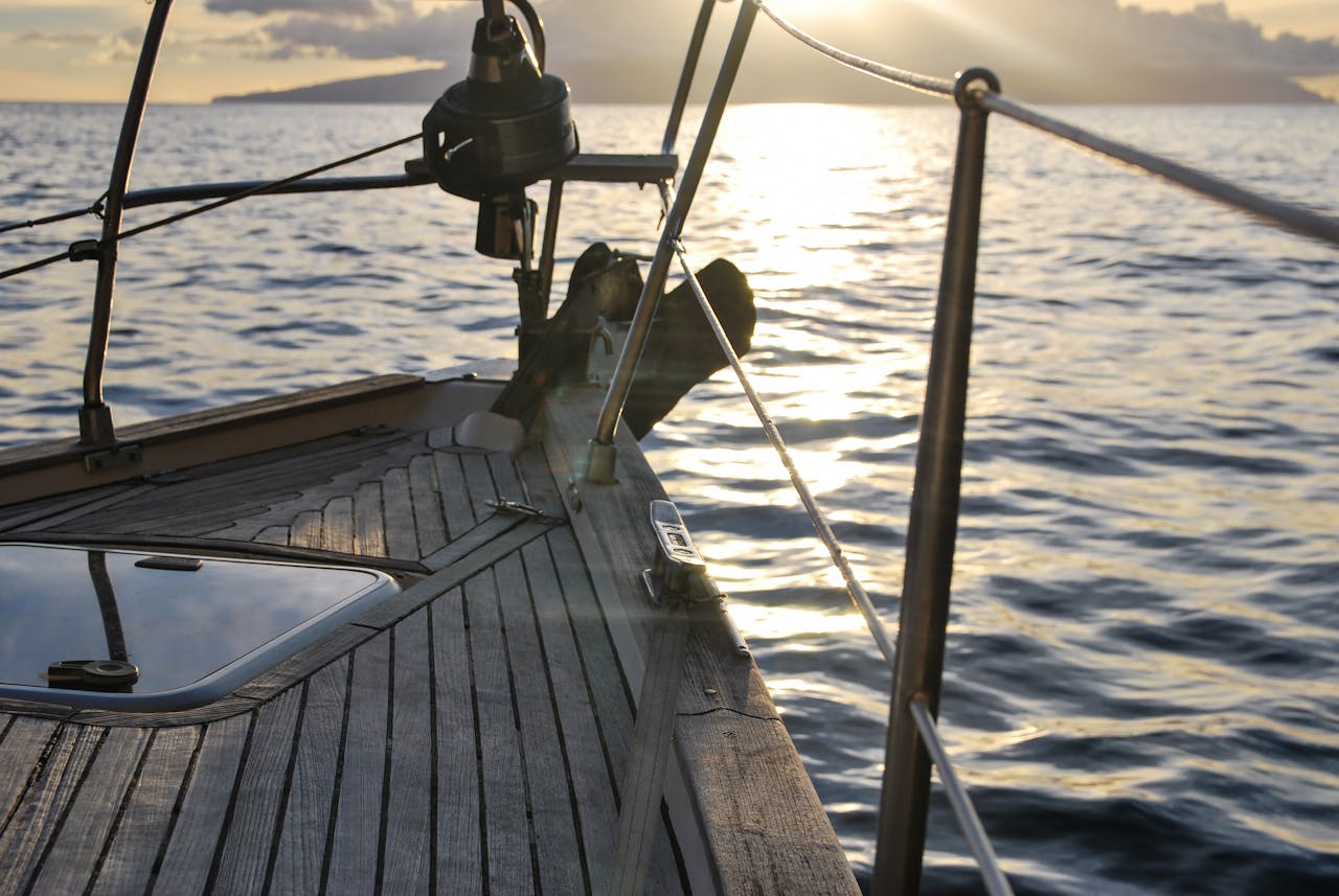 Experience serene sailing at sunset aboard a yacht navigating open waters.